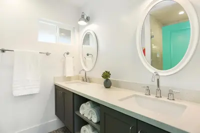 a bathroom with two sinks and a mirror at Peace Palace 56 in Los Angeles
