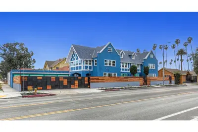 a large blue house on the side of a street at Peace Palace 56 in Los Angeles
