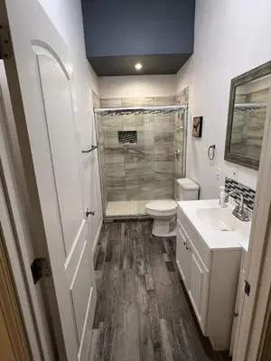 a bathroom with a shower and a toilet and a sink at Wofford Village Studios in Wofford Heights