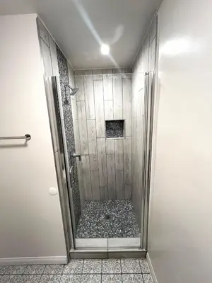 a shower with a glass door in a bathroom at Wofford Village Studios in Wofford Heights