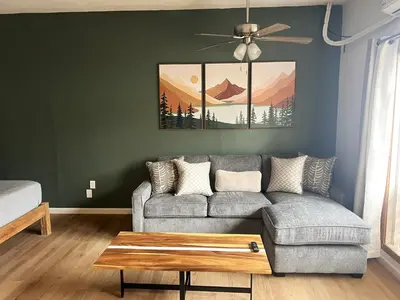 a living room with a couch and a table at Wofford Village Studios in Wofford Heights