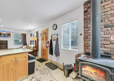 a kitchen with a fireplace and a brick wall at Merri Bear in Big Bear Lake