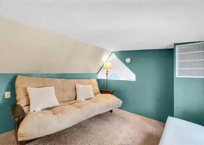 a couch sitting in a room with blue walls at Merri Bear in Big Bear Lake