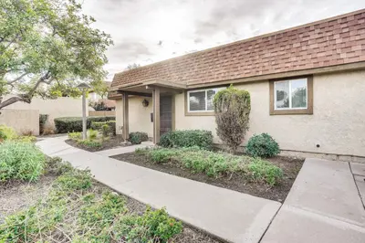 a house with a sidewalk in front of it at Rental with Pool Access about 8 Mi to Disneyland in La Palma