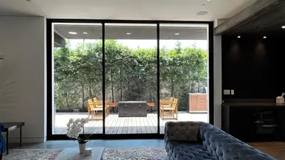 a living room with a couch and a large glass door at Luxurious Venice Oasis Home in Los Angeles