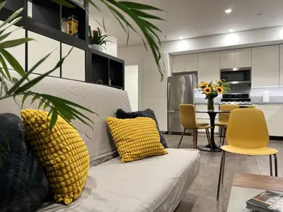 a living room with a white couch with yellow pillows at Cozy Luxerius 1 bed Loft Venice in Los Angeles