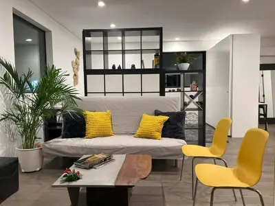 a living room with a couch and two yellow chairs at Cozy Luxerius 1 bed Loft Venice in Los Angeles