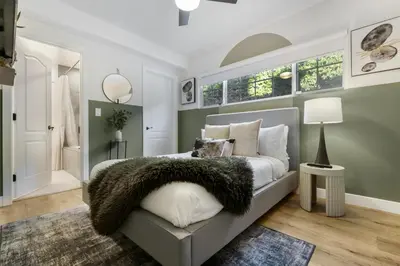 a bedroom with a gray bed with a furry pillow at Erwin Estate in Los Angeles