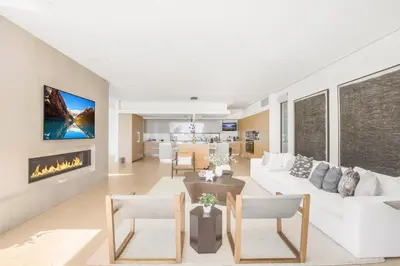 a living room with a white couch and a fireplace at Swallow Sanctuary in Los Angeles