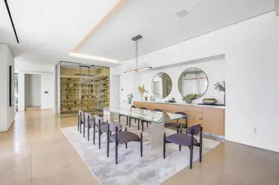 a dining room with a table and chairs and mirrors at Swallow Sanctuary in Los Angeles