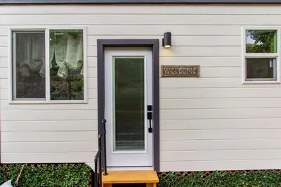 a front door of a house with a window at Tiny Farmhouse on Wheels in Santa Clarita