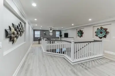 a white staircase in a home with white walls at 5BR 3BA Home - King Beds - Fast Wifi home in Victorville