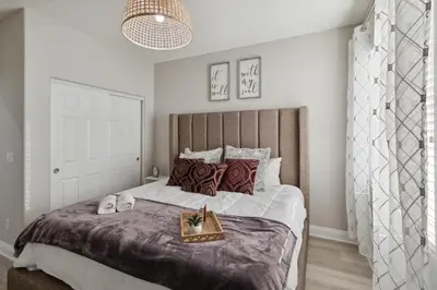 a bedroom with a large bed with a tray on it at 5BR 3BA Home - King Beds - Fast Wifi home in Victorville