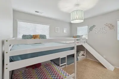 a bedroom with a bunk bed with a teddy bear at 5BR 3BA Home - King Beds - Fast Wifi home in Victorville