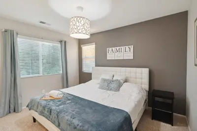 a bedroom with a bed and a pendant light at 5BR 3BA Home - King Beds - Fast Wifi home in Victorville