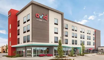 an office building with a sign on the side of it at avid hotel Victorville Hesperia by IHG in Victorville