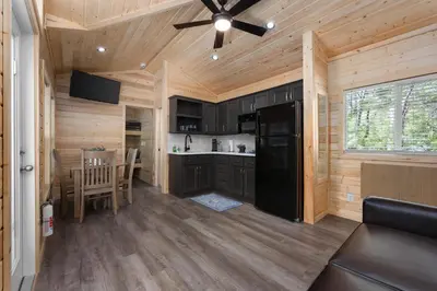a kitchen and dining room of a log cabin at Brand New Cabin in Kernville