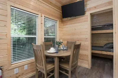 a dining room with a table and chairs at Brand New Cabin in Kernville
