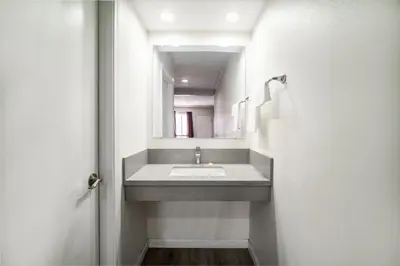 a bathroom with a sink and a mirror at Bell Manor Motel in Bell