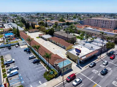 an aerial view of a city with a parking lot at Bell Manor Motel in Bell