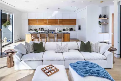 a living room with a couch and a kitchen at The Penmar Retreat - Luxurious resort-style oasis in Los Angeles