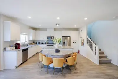 a large white kitchen with a table and chairs at Up to 25% OFF / New Built for Ideal Extended Stay in Fontana