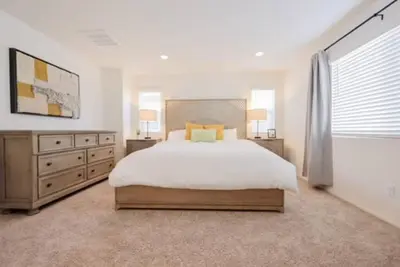 a bedroom with a large bed and a large window at Up to 25% OFF / New Built for Ideal Extended Stay in Fontana