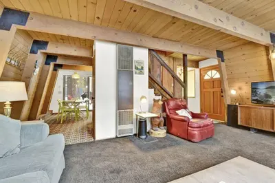 a living room with a couch and a chair at Quail's Call Big Bear~ Walk to Lake & Ski Resort in Big Bear Lake