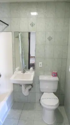 a bathroom with a white toilet and a sink at Eagle Rock Motel in Los Angeles
