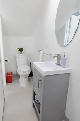 a white bathroom with a toilet and a mirror at 2BD/2BA Apartment in DT ALhambra in Alhambra