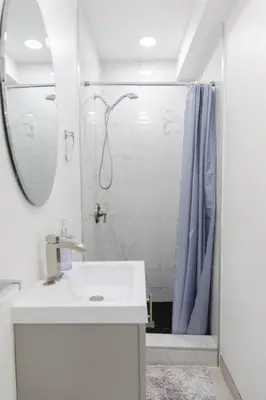 a white bathroom with a shower and a sink at 2BD/2BA Apartment in DT ALhambra in Alhambra