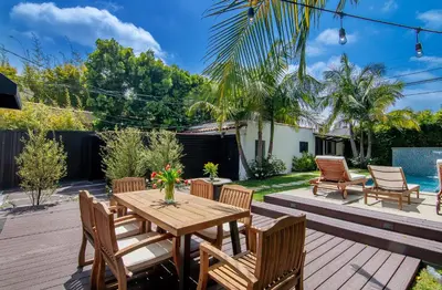 a patio with a wooden table and chairs at Beautiful Large 3 Bedroom 2 Bath Plus Pool and Jacuzzi in Los Angeles