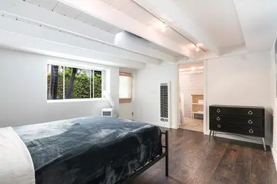 a bedroom with a bed and a dresser and a window at Beautiful Large 3 Bedroom 2 Bath Plus Pool and Jacuzzi in Los Angeles