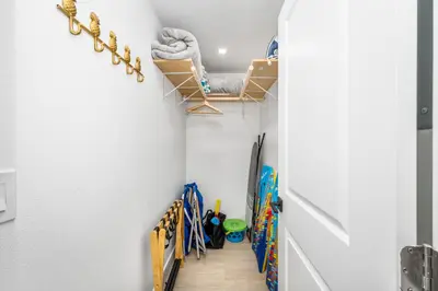 a walk in closet with skis on the wall at 130 Anderson St A in Sunset Beach