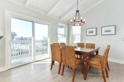 a dining room with a wooden table and chairs at Sunset Island 3 Level Home on the Water sleeps 10 in Sunset Beach