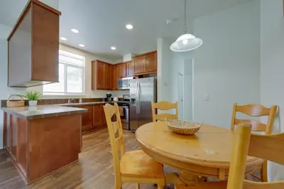 a kitchen with a wooden table and a dining room at Oak View Home with Private Covered Patio! in Oak View