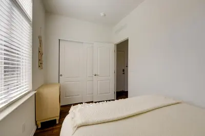 a white bedroom with a bed and a window at Oak View Home with Private Covered Patio! in Oak View