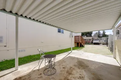 a patio with a chair under awning at Oak View Home with Private Covered Patio! in Oak View