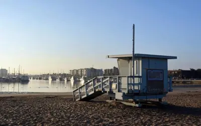 a lifeguard station on a beach next to the water at Sunny Condo with Panoramic Ocean Views in Los Angeles