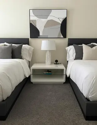 a bedroom with two beds and a table with a lamp at Partial Ocean View Steps to the Pier in Los Angeles