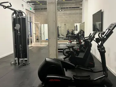 a gym with a row of exercise bikes in a room at Large Hollywood Corner 2 Bedroom with Private Balcony in Los Angeles