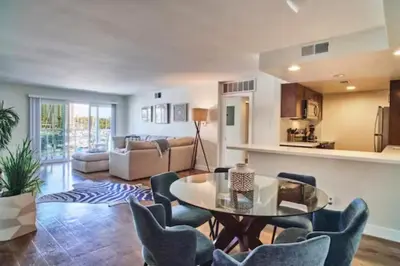 a living room with a glass table and chairs at Blue Agate - Seaside Bright 2BR with Marina Views in Los Angeles