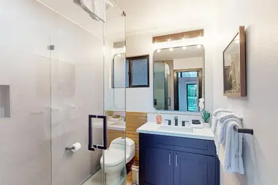 a bathroom with a sink and a toilet and a mirror at The Snow White in Lake Arrowhead