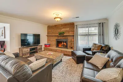 a living room with leather furniture and a fireplace at Family-Friendly Loma Linda Retreat Walk to LLU in Loma Linda