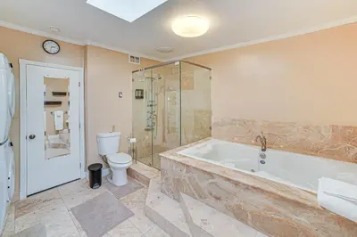 a large bathroom with a tub and a toilet at Family-Friendly Loma Linda Retreat Walk to LLU in Loma Linda