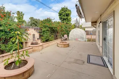 an empty patio with plants and a fence at Family-Friendly Loma Linda Retreat Walk to LLU in Loma Linda