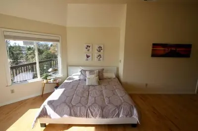 a bedroom with a large bed and a window at Outrageous Lake View Villa pets ok in Lake Arrowhead