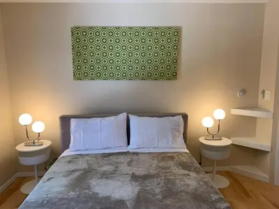 a bedroom with a bed with two tables and two lamps at Outrageous Lake View Villa pets ok in Lake Arrowhead