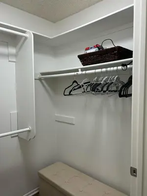 a white closet with a rack of shoes at Hollywood Blvd Studio FREE DESIGNATED PARKING & WIFI in Los Angeles