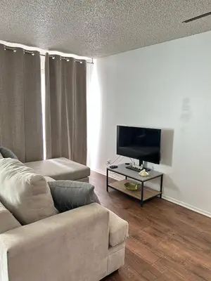 a living room with a couch and a tv at Hollywood Blvd Studio FREE DESIGNATED PARKING & WIFI in Los Angeles